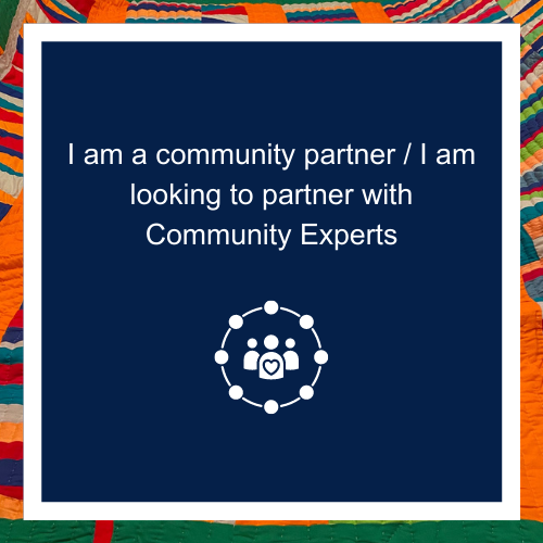 Navy poster with colorful, tribal print borders. Inside the poster reads: "I am a community partner/ I am looking to partner with Community Experts". Below text is a figure of 3 people with a heart outlined inside the middle person.